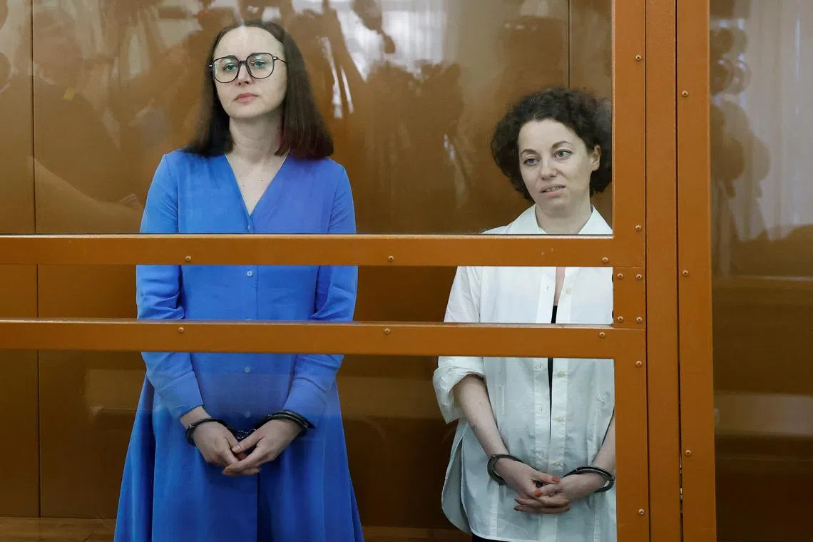 Director Zhenya Berkovich and playwright Svetlana Petriychuk, who were arrested in May 2023 over the play \"Finist the Bright Falcon\" and accused of justifying terrorism, stand inside an enclosure for defendants during a court hearing in Moscow, Russia July 8, 2024. REUTERS/Yulia Morozova