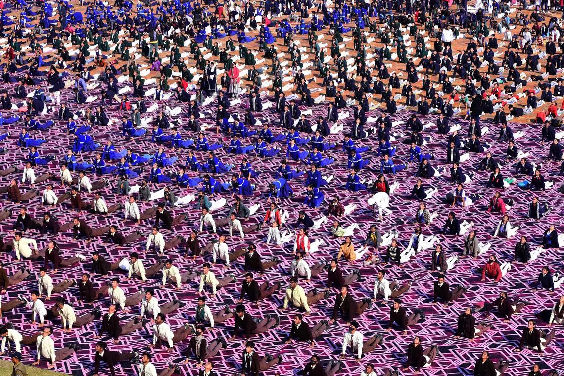 School students gather to practice yoga on the occasion of National Youth Day which is celebrated on the birth anniversary of Swami Vivekananda, an Indian Hindu monk, philosopher, author and religious teacher, at Ranital stadium on January 12, 2023. 