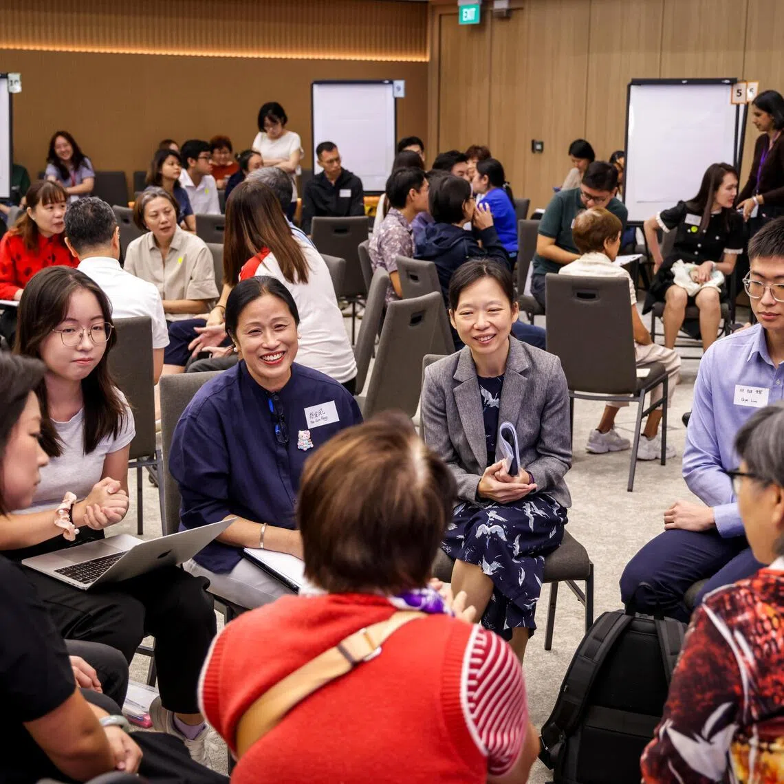 Minister of State for Education, and Digital Development and Information Jasmin Lau (in jacket) participating in a small group discussion at a public engagement session about the future of education on July 26.