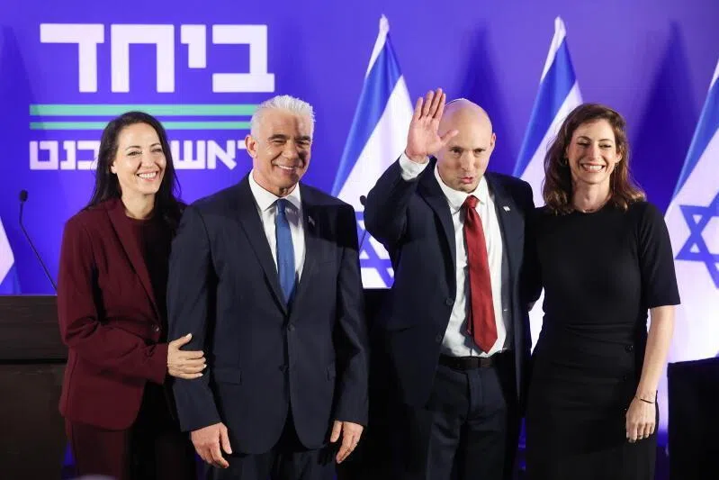 Former Israeli prime ministers Naftali Bennett (second from right) and Mr Yair Lapid, accompanied by their wives at a joint press conference in Herzliya, Israel, on April 26.