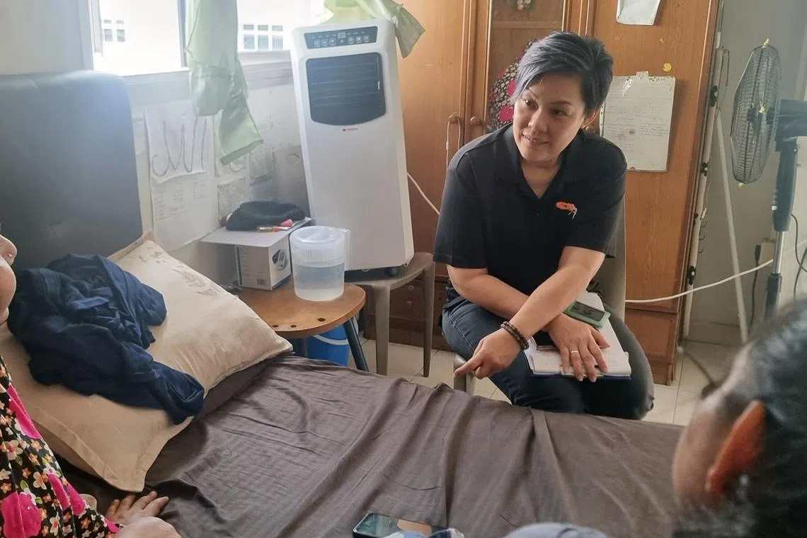 msf family coach speaking with low income family in singapore in rental apartment and discuss possible social and financial assistance