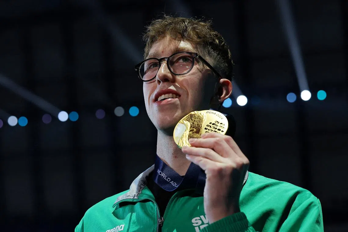 FILE PHOTO: Swimming - World Aquatics Championships - Aspire Dome, Doha, Qatar - February 18, 2024 Ireland's Daniel Wiffen celebrates on the podium with the gold medal after winning the men's 1500m freestyle final REUTERS/Evgenia Novozhenina/File Photo
