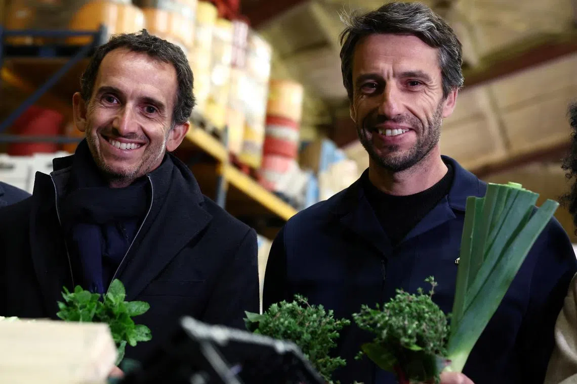 Alexandre Bompard, Chairman and Chief Executive Officer of French retailer Carrefour, and Tony Estanguet, President of the Organising Committee of the Paris 2024 Olympic and Paralympic Games,  pose with herbs and vegetables during a visit at the Vaulerand potato farm as French supermarket giant and Paris 2024 sponsor Carrefour presents its strategy to provide fresh products for athletes during the Paris 2024 Olympic and Paralympic Games, in Villeron, near Paris, France, April 18, 2024. REUTERS/Stephanie Lecocq