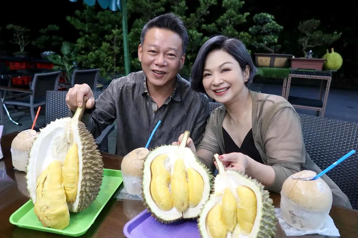 Taiwanese stars Lee Kang-sheng (left) and Yang Kuei-mei (right) enjoy Mao Shan Wang durian while in Singapore to attend the Singapore International Film Festival.
