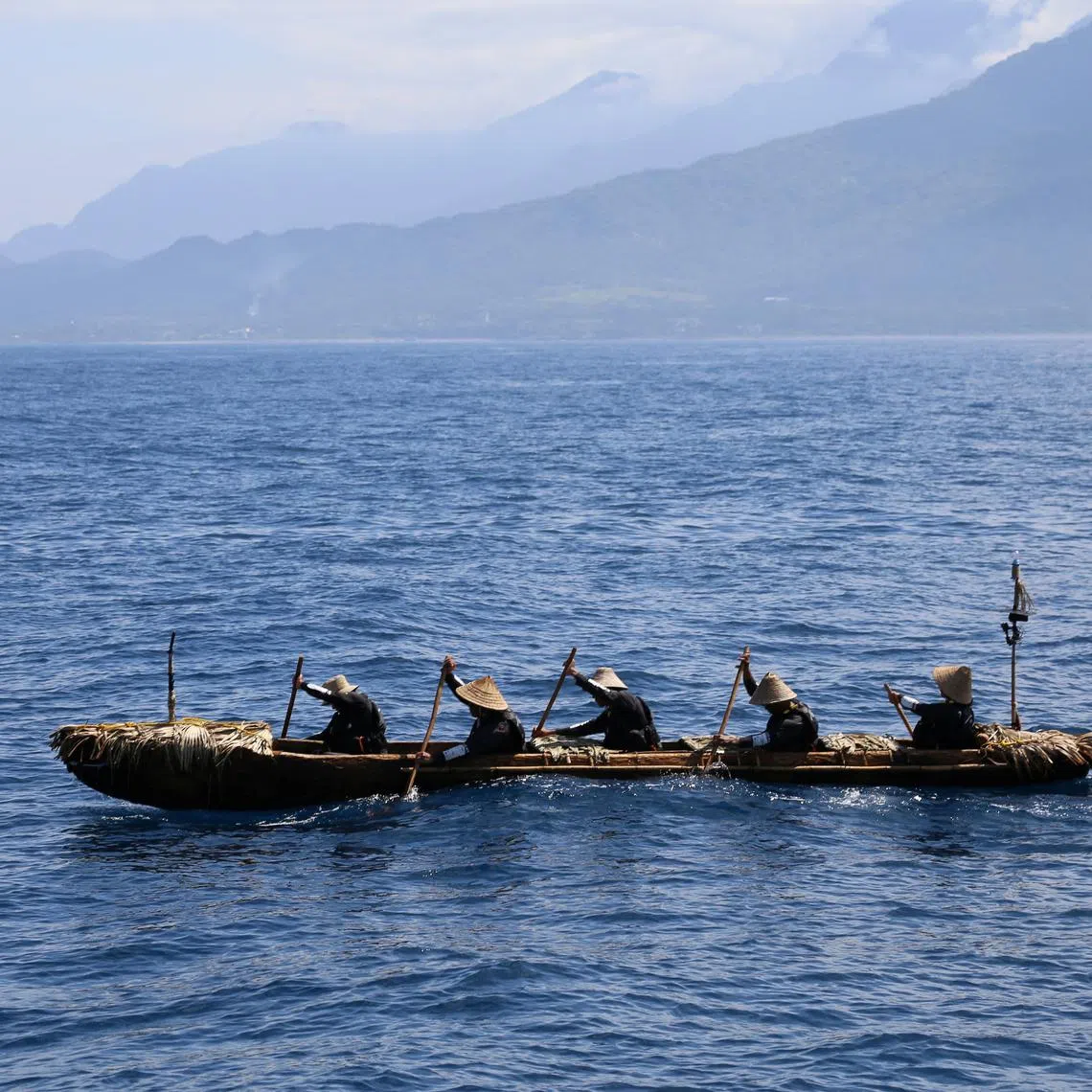 A dugout canoe with four men and one woman paddling is pictured during a crossing across a region of the East China Sea from near Ushibi, Taiwan to Yonaguni Island, traversing the Kuroshio current, in this handout image released on June 25, 2025. Yousuke Kaifu/Handout via REUTERS