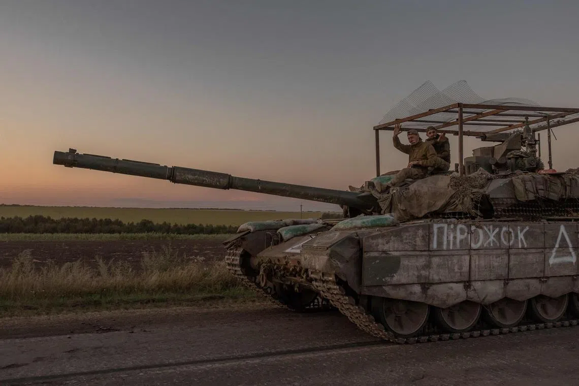 Ukrainian servicemen on a tank near the border with Russia, in the Sumy region of Ukraine, on Aug 14.