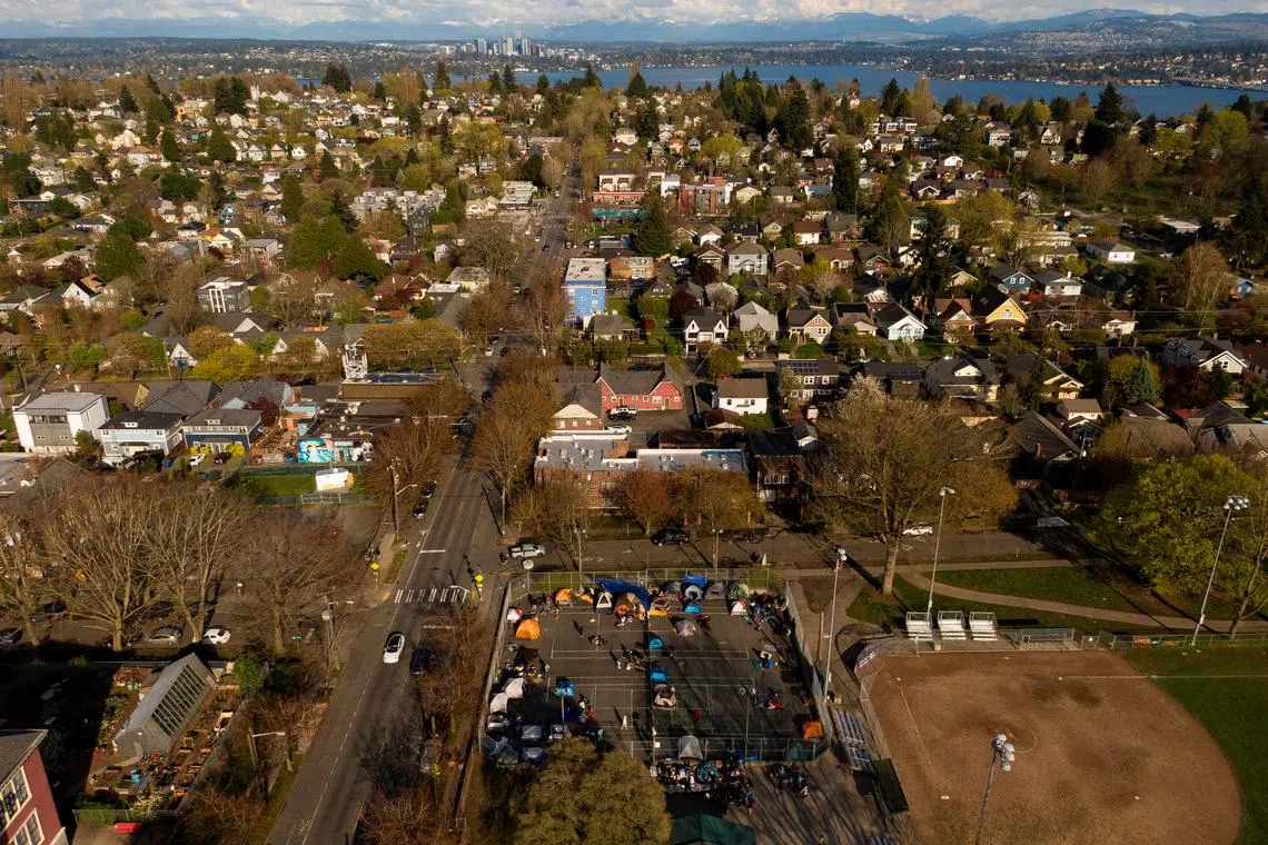 FILE PHOTO: In an aerial photograph taken with a drone, a group of mostly Venezuelan migrants camp on the tennis courts of a community center after losing access to other shelter in Seattle, Washington , U.S. April 3, 2024.  REUTERS/David Ryder/File Photo
