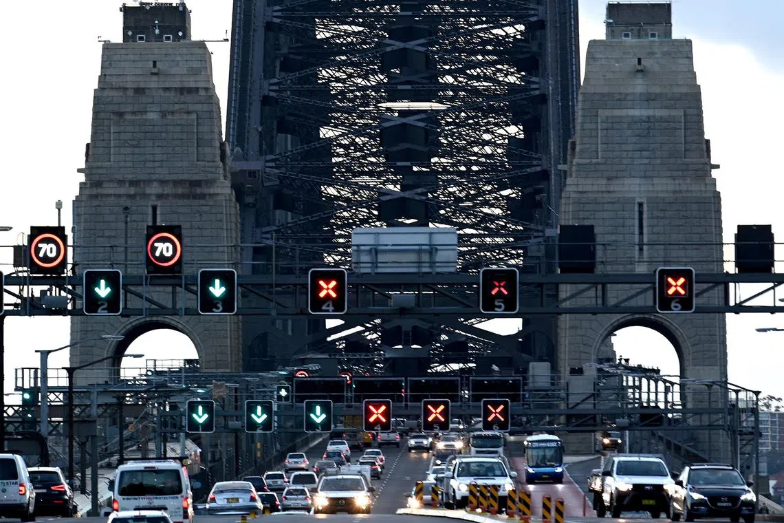 Early morning traffic is seen on the Harbour Bridge in Sydney on May 15, 2020. - The New South Wales state relaxed COVID-19 restrictions around public gathering and businesses from today. (Photo by Saeed KHAN / AFP)