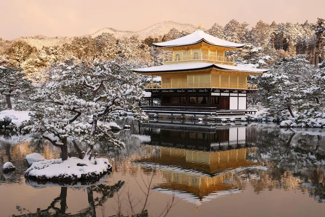 The grounds of Kinkakuji temple - the Golden Pavilion - are covered with snow in Kyoto on January 25, 2023, after heavy snow and strong winds overnight affected wide areas of the country. 