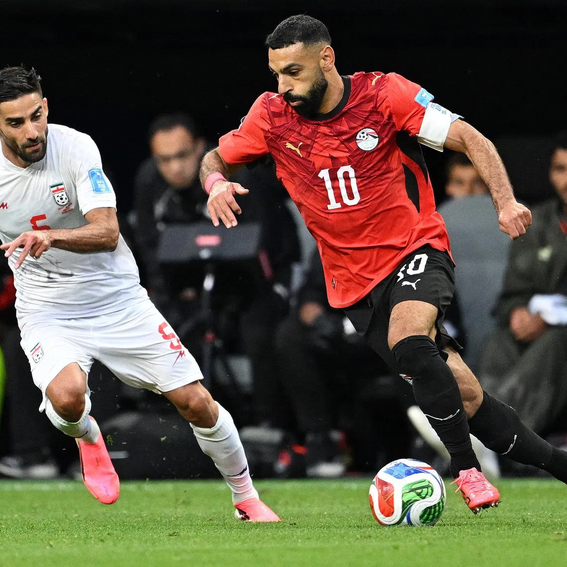 Soccer Football - FIFA World Cup 2026 - Group G - Egypt v Iran - Seattle Stadium, Seattle, Washington, U.S. - June 26, 2026 Iran's Milad Mohammadi in action with Egypt's Mohamed Salah REUTERS/Troy Wayrynen