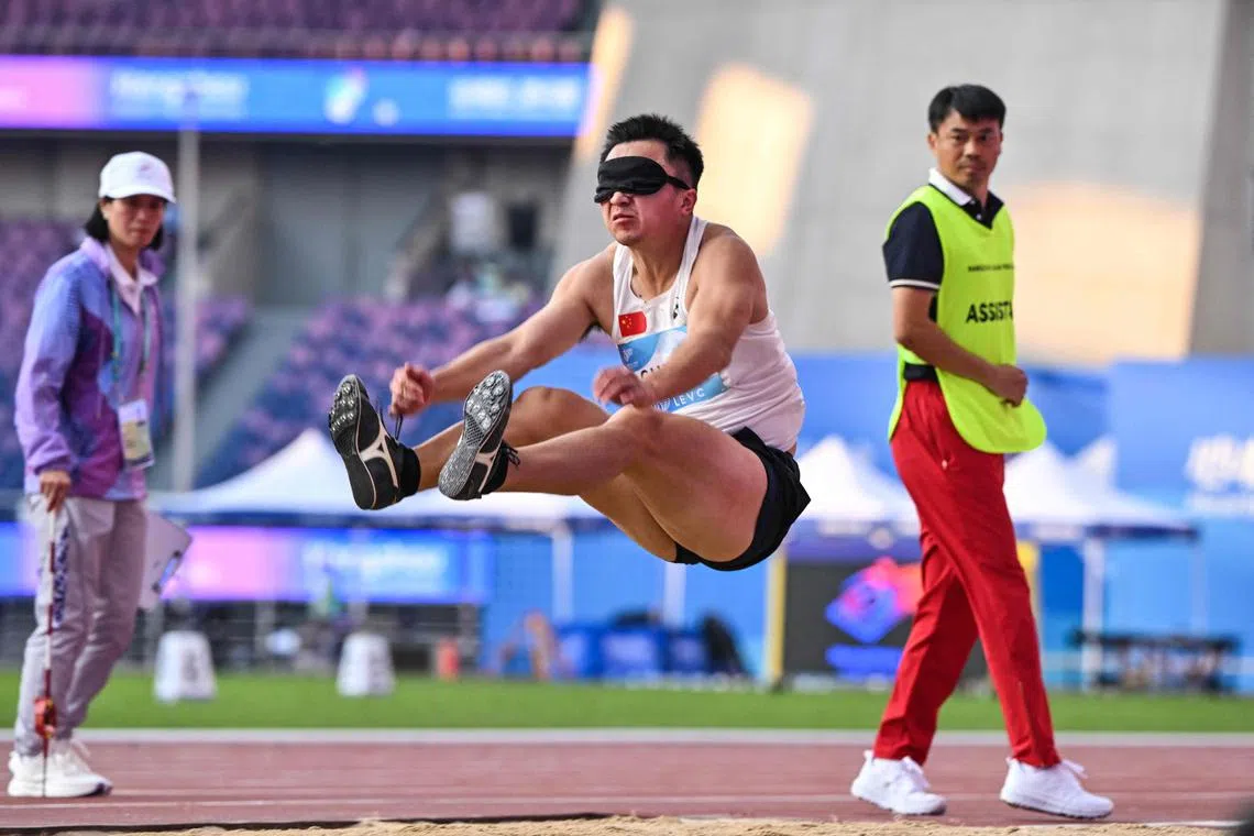 China's Chen Xingyu competing in the men's long jump T11 final at the Huanglong Sport Centre Stadium during the Asian Para Games in Hangzhou on Oct 23, 2023.