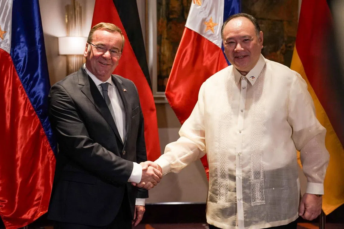 German Defence Minister Boris Pistorius and Philippine Defence Minister Gilberto Teodoro shake hands before their bilateral meeting, in Makati, Metro Manila, on Aug 4, 2024.