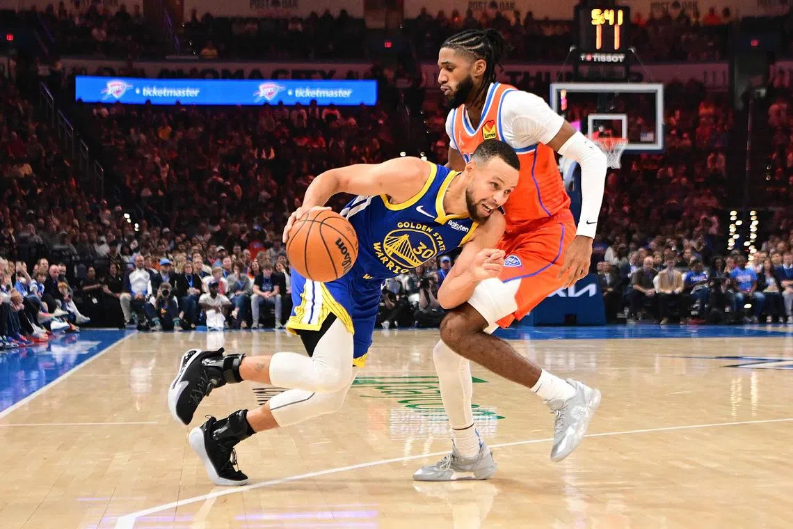 Stephen Curry of the Golden State Warriors drives against Isaiah Joe of the Oklahoma City Thunder during the first half at Paycom Centre on Nov 10, 2024 in Oklahoma City.