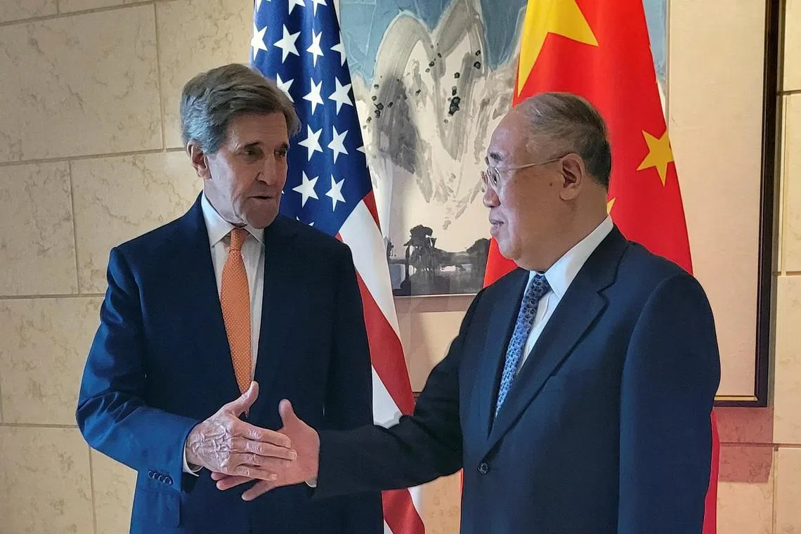 US Special Presidential Envoy for Climate John Kerry shakes hands with his Chinese counterpart Xie Zhenhua before a meeting in Beijing.
