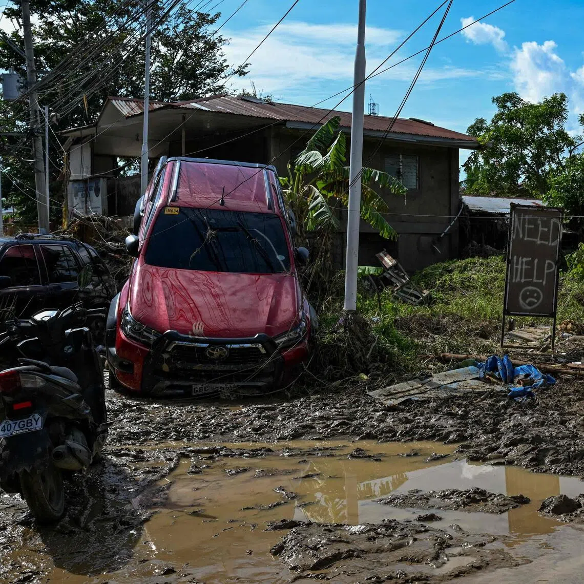 Cars piled atop each other by floodwaters and roofs torn off buildings as residents attempted to dig out of the mud at Liloan, a town near Cebu city.