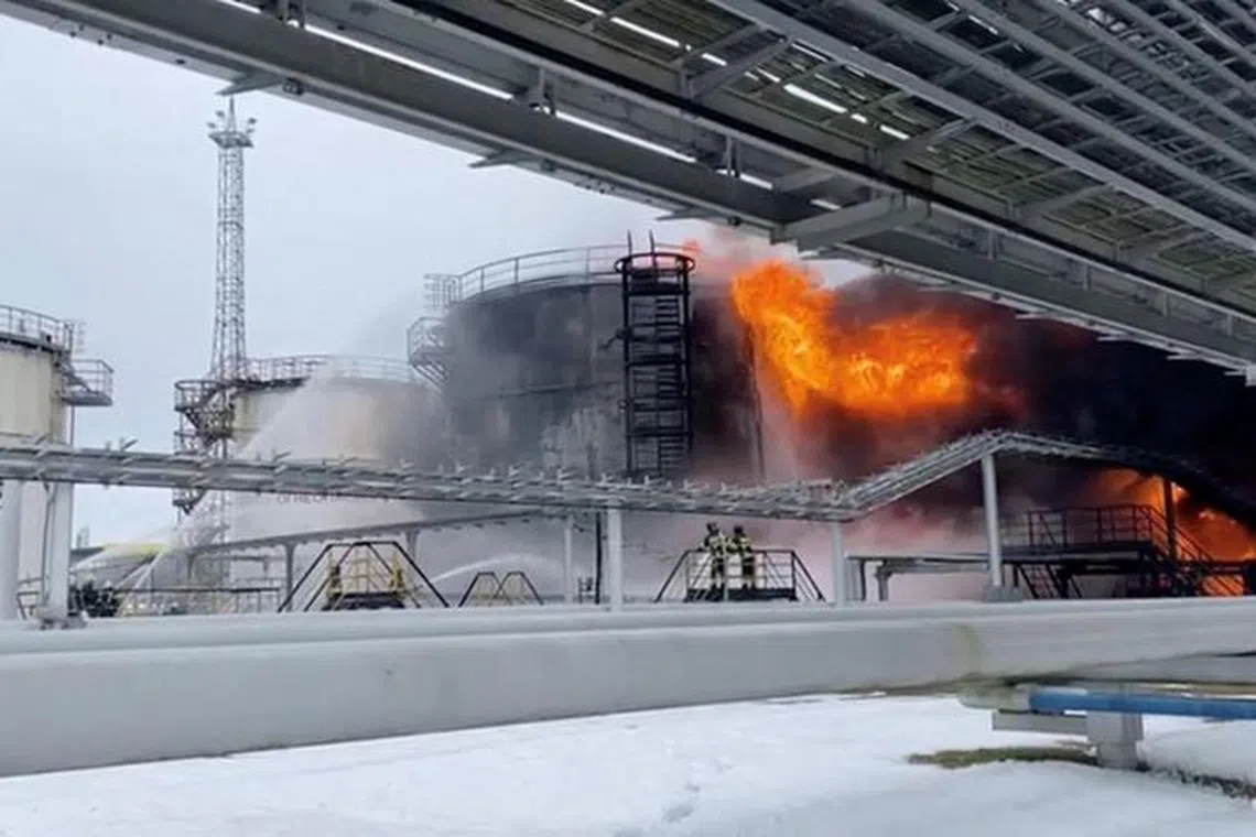 FILE PHOTO: Firefighters extinguish oil tanks at a storage facility that local authorities say caught fire after the military brought down a Ukrainian drone, in the town of Klintsy in the Bryansk Region, Russia January 19, 2024, in this still image taken from video. Russian Emergencies Ministry/Handout via REUTERS/File Photo