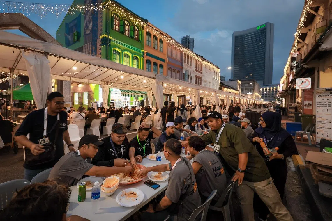 Attendees and beneficiaries breaking fast at the Gemilang Kampong Gelam Mass Iftar held at Arab Street on March 22, 2025.