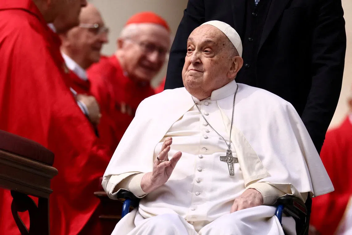 FILE PHOTO: Pope Francis greets cardinals as he unexpectedly appears during the Palm Sunday Mass in Saint Peter's Square at the Vatican, April 13, 2025. REUTERS/Yara Nardi/File Photo