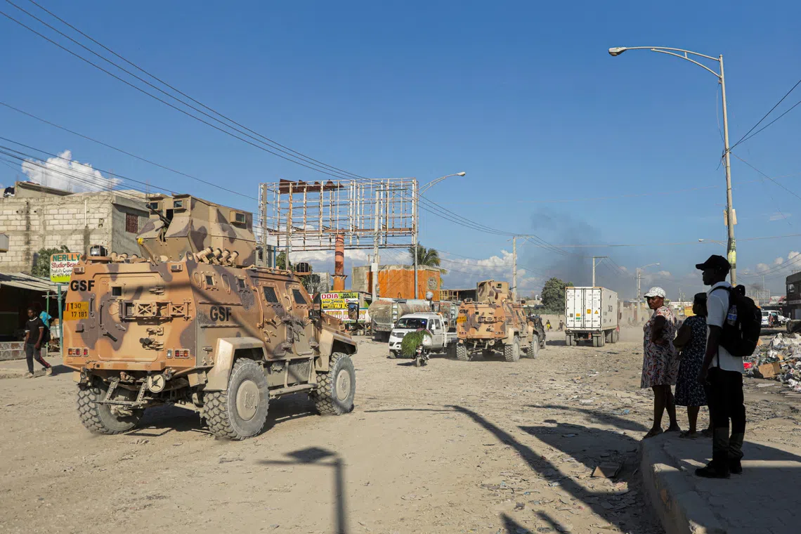 Armored personnel carriers of Haiti's UN-backed Gang Suppression Force (GSF) patrol an area after heavily armed gangs ambushed members of the force, attacking their armored vehicle with explosives, setting it ablaze and leaving four Salvadoran troops missing when they fled their burning vehicle, in Port-au-Prince, Haiti, October 19, 2026. REUTERS/Patrice Noel