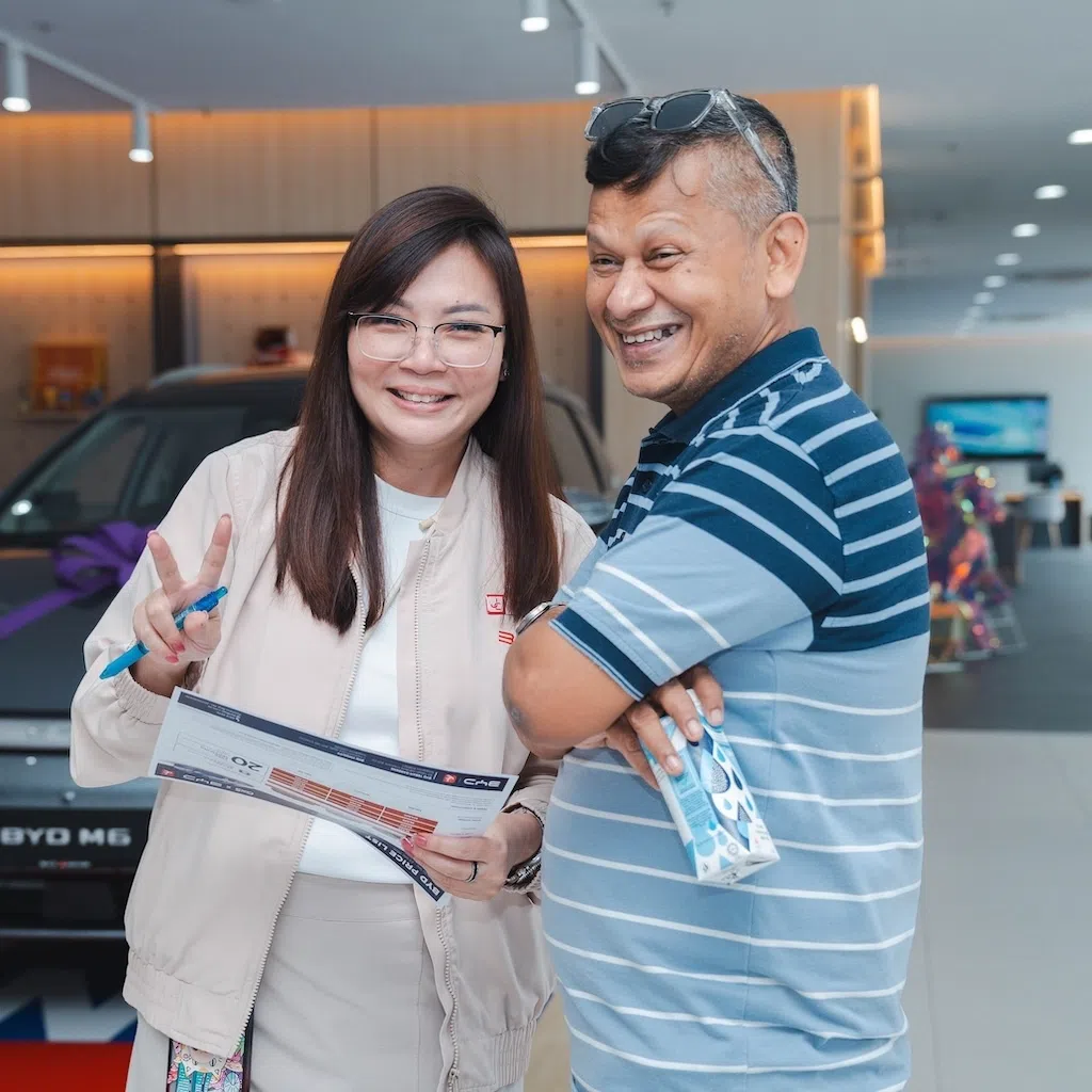 PHV driver Sheik Ismail Mohamed Faisal with BYD by JC sales consultant Priscillia Yeo.