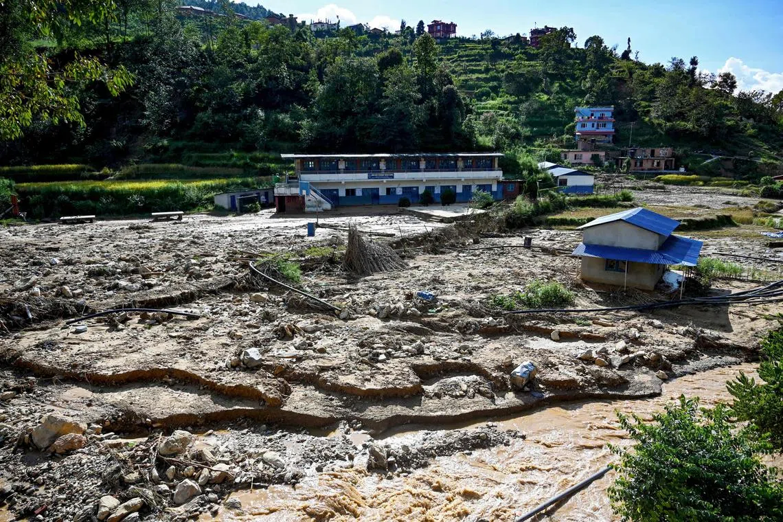 (FILES) A general view shows a landslide-affected village, following heavy rains in Lalitpur district on the outskirts of Kathmandu on October 1, 2024. Every year during monsoon, floods and landslides wreak havoc across South Asia, killing hundreds of people. Nepal is especially vulnerable due to unstable geology, shifting rainfall patterns, and poorly planned development. (Photo by Prakash MATHEMA / AFP)