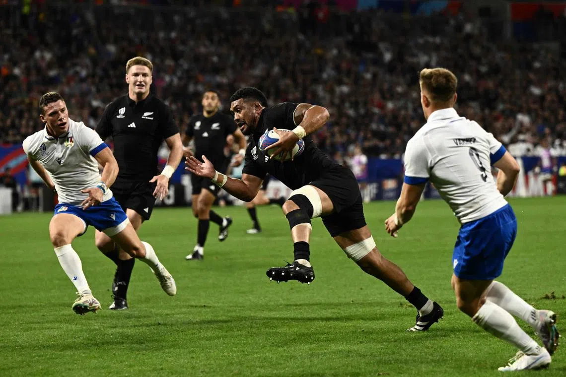 New Zealand's No. 8 Ardie Savea runs to score a try during the 96-17 thrashing of Italy in the Rugby World Cup.
