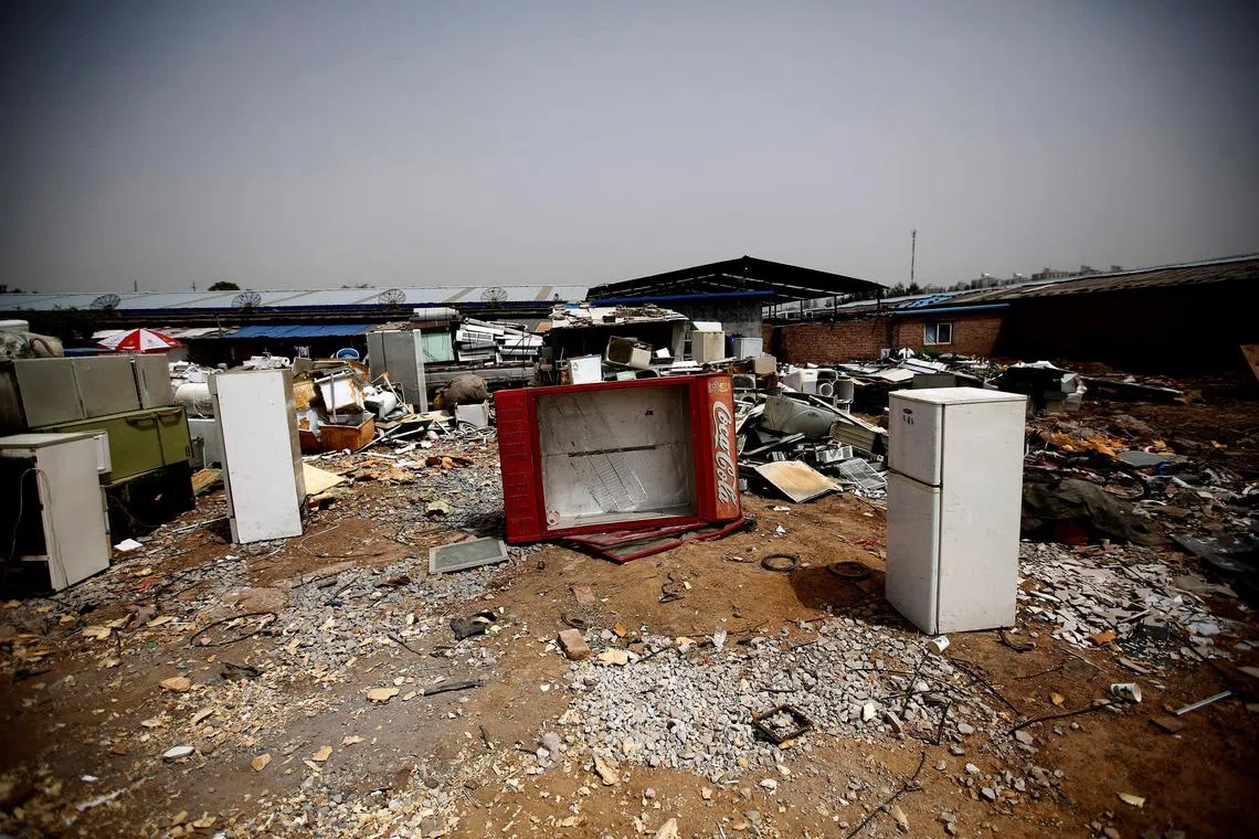 FILE PHOTO: Broken fridges are seen in the yard of a recycling workers' tenement house in Dongxiaokou village in Beijing May 15, 2014.  REUTERS/Kim Kyung-Hoon/File Photo