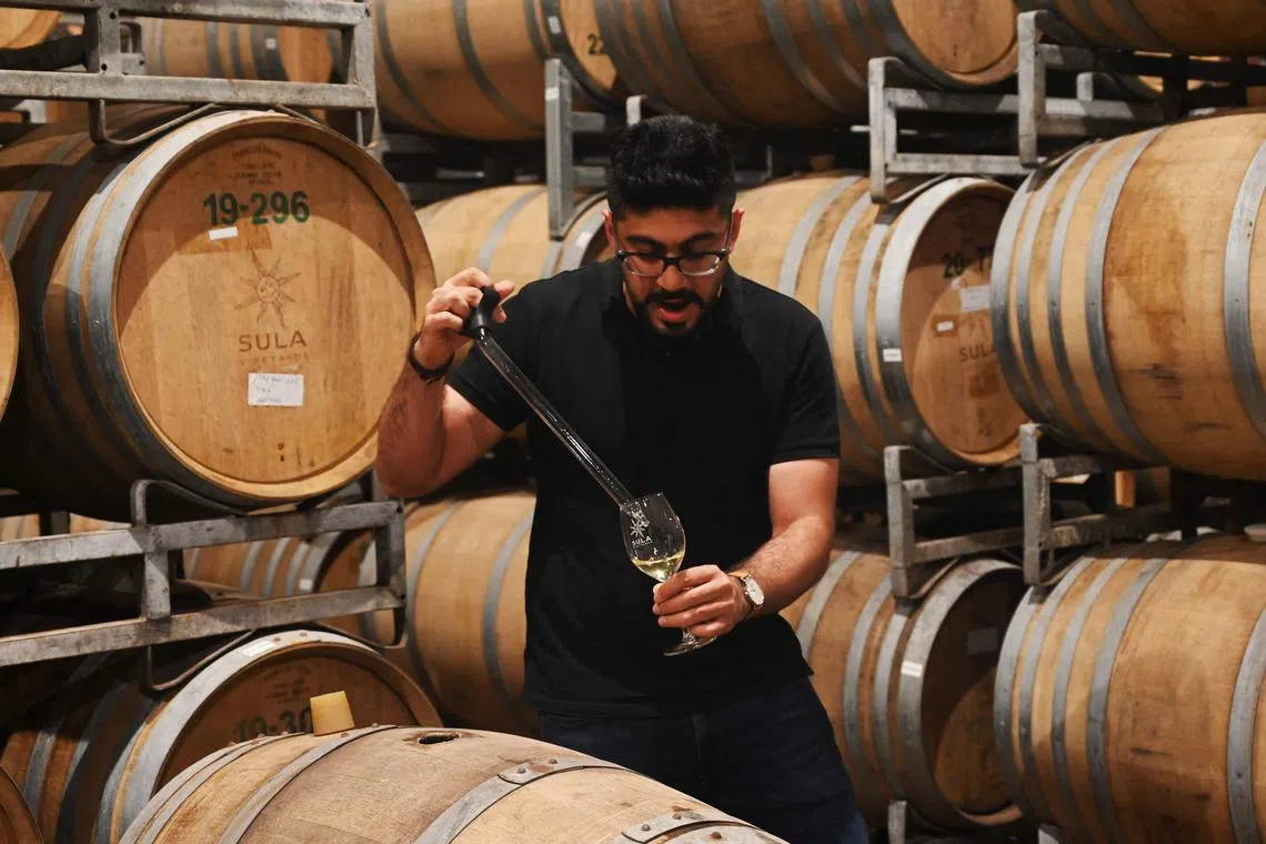 Mr Karan Vasani, chief winemaker at Sula, checks a batch of wine at a vineyard in Nashik city, India.