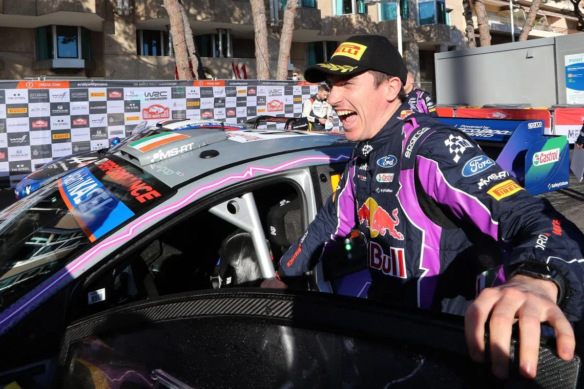 A January 2022 photo shows Irish driver Craig Breen celebrating third place in the 90th WRC Monte-Carlo Rally, in Monaco.