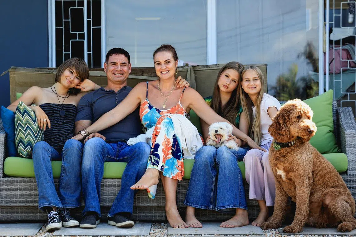 Naomi and Danny Saphire pose with their children and dogs at their new home in Plettenberg Bay after returning from the U.S., in the Western Cape, South Africa, March 7, 2026.