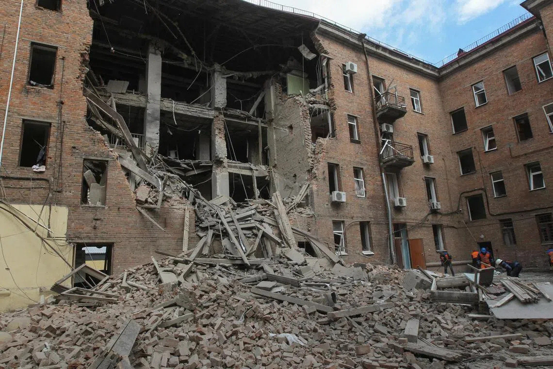 Municipal workers removing debris after Russian drones hit a residential building in Dnipro, Ukraine, on April 25.