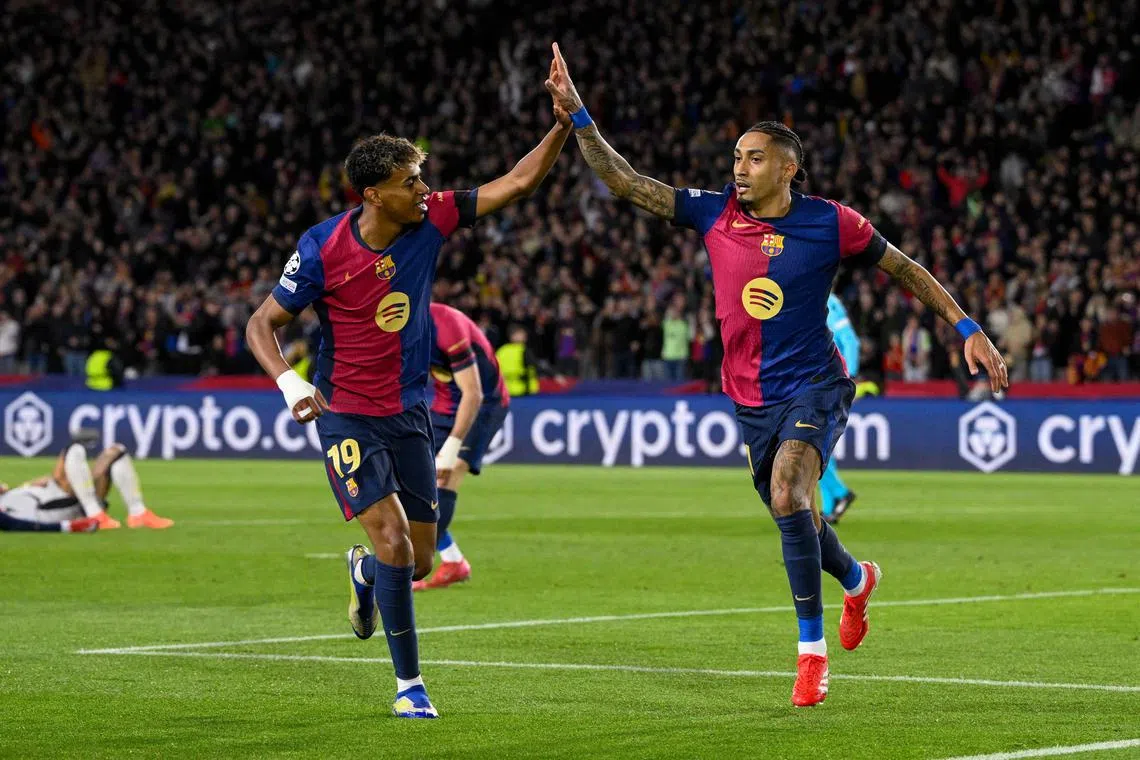 Barcelona forward Raphinha (right) celebrates with teammate Lamine Yamal after scoring his team's third goal.