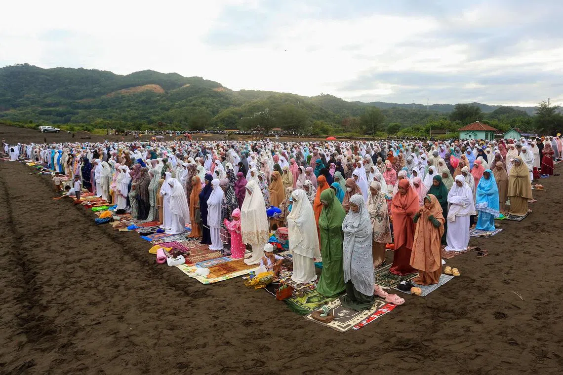 Muslims attending Eid al-Fitr prayers, marking the end of the holy month of Ramadan, at Parangkusumo sand dunes in Bantul, Yogyakarta, on April 10, 2024. 