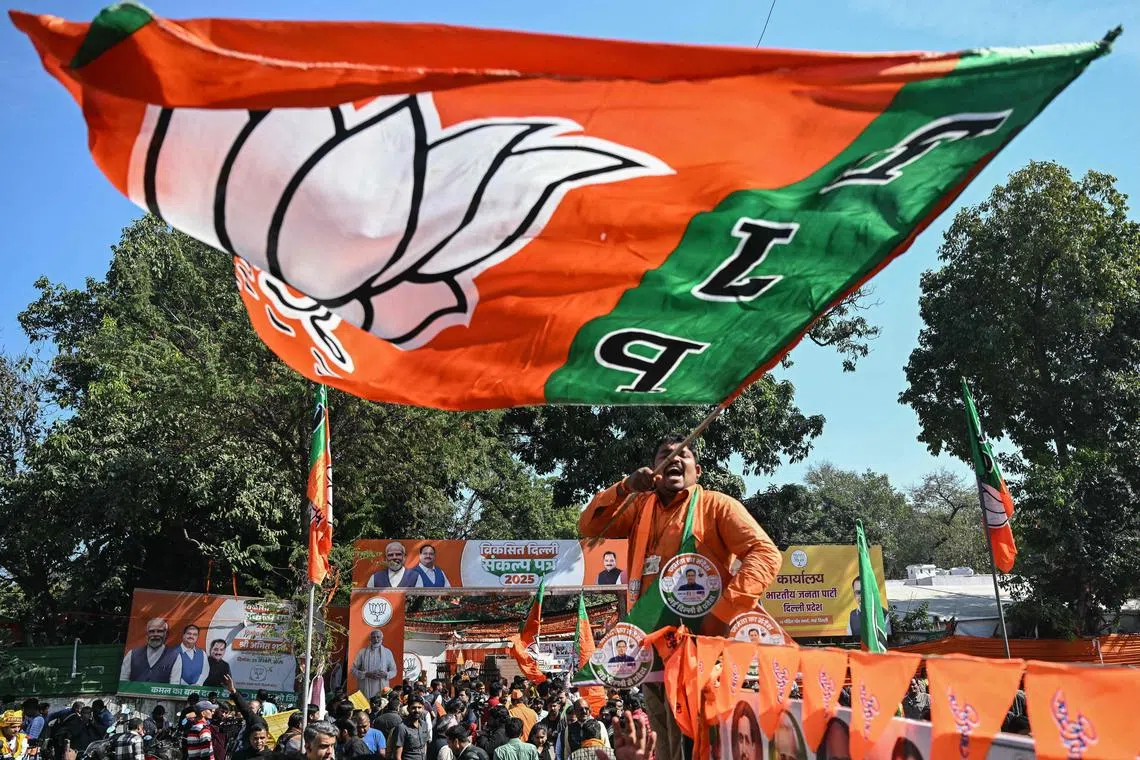 Supporters of the Bharatiya Janata Party (BJP) celebrate as BJP leads in vote counting for the Delhi legislative assembly election outside the party's state headquarters in New Delhi on Feb 8, 2025.