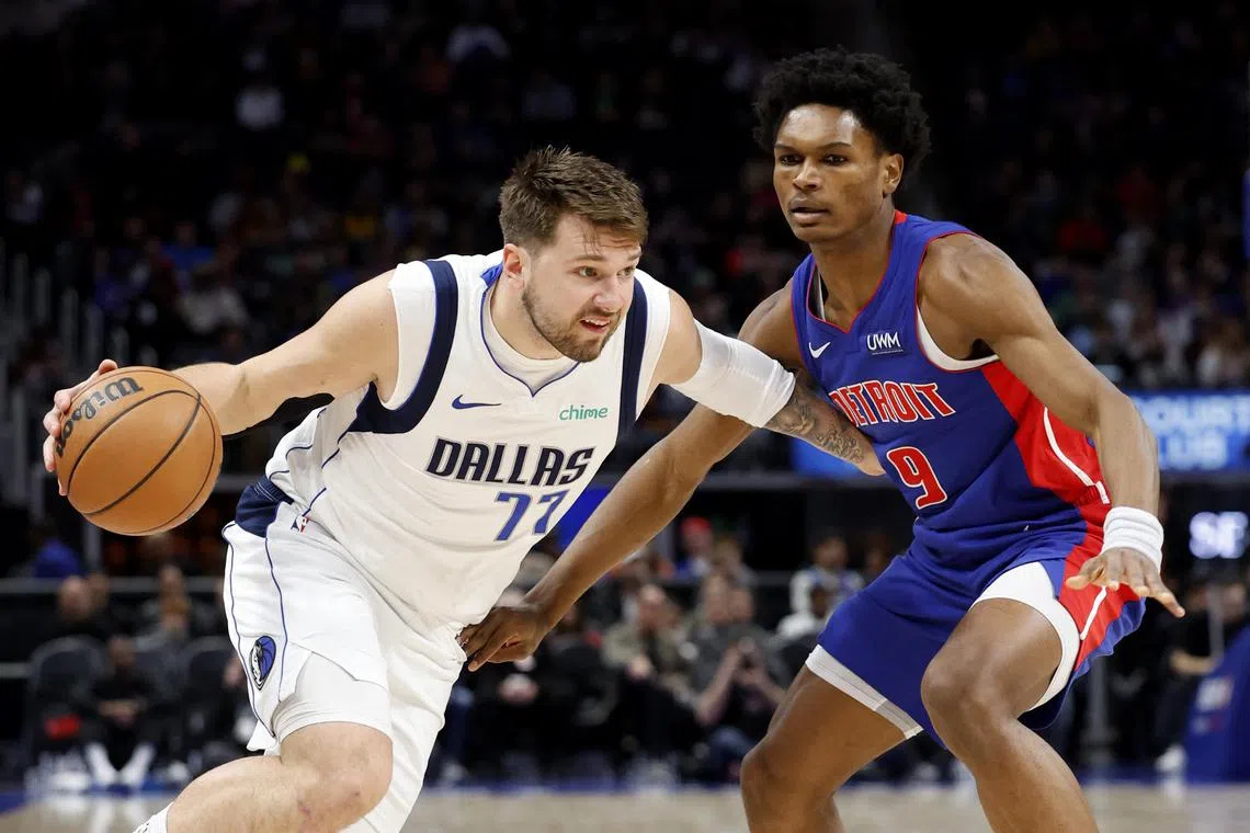 Dallas Mavericks guard Luka Doncic dribbles against Detroit Pistons forward Ausar Thompson in the first half at Little Caesars Arena.