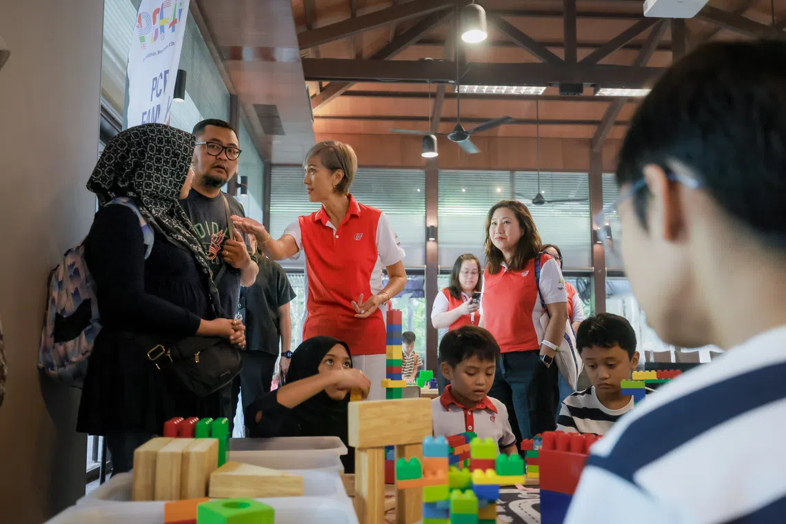 PCF Council of Management chairperson Josephine Teo (centre) interacts with families at the zoo during the PCF40 Family Day at Mandai Wildlife Reserve on Oct 11.
