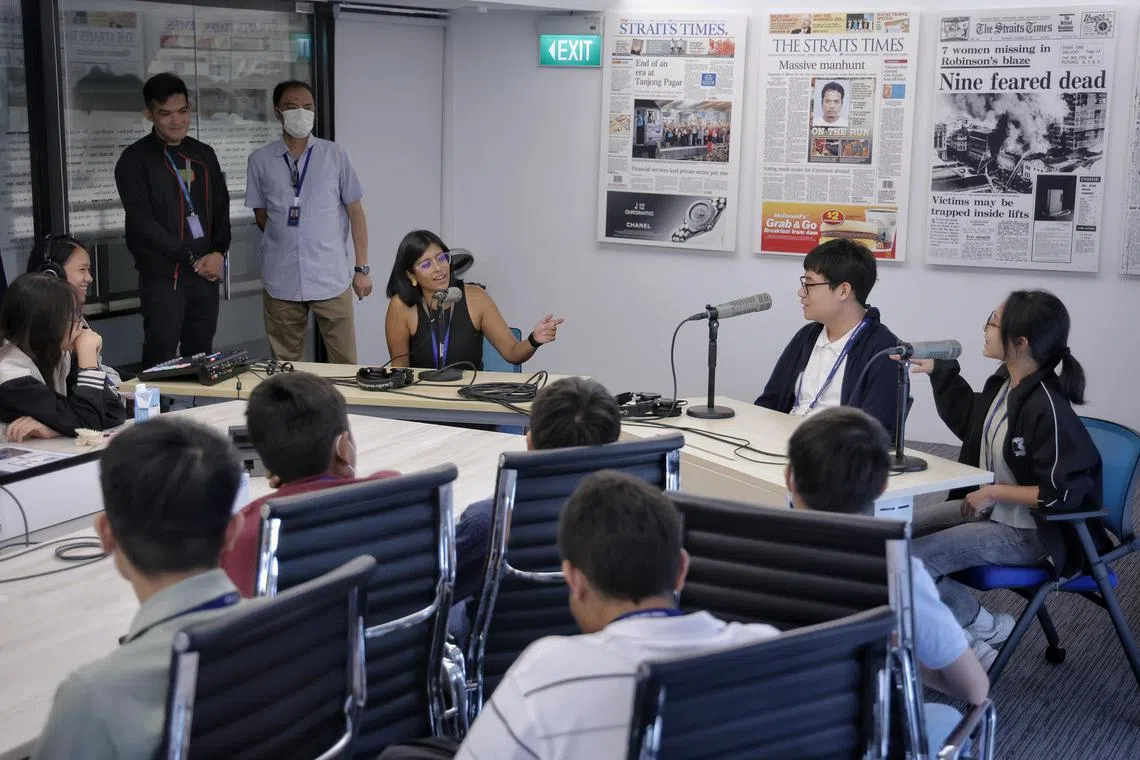 Correspondent and host of The Usual Place podcast Natasha Zachariah giving Gregory Ng (second form right), 15, Secondary 3 student from Raffles Institution, and Fayth Wai (right), 14, Secondary 2 student from Fairfield Methodist Secondary School, a hands on experience in podcasting during The Straits Times’ journalism programme for youths in SPH Media on June 4, 2024. ST's journalism programme for youths is a part of our outreach efforts to the community.