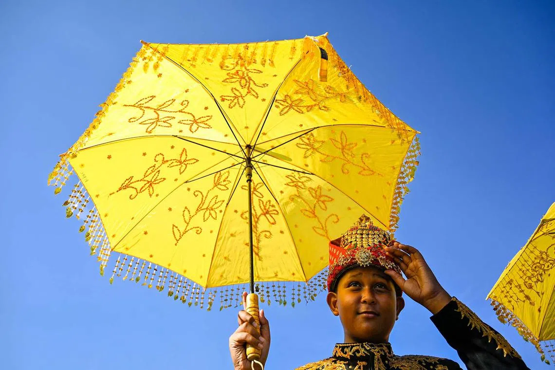 A participant takes part in a cultural carnival during celebrations marking Indonesia's 80th Independence day in Banda Aceh on Aug 18, 2025. 