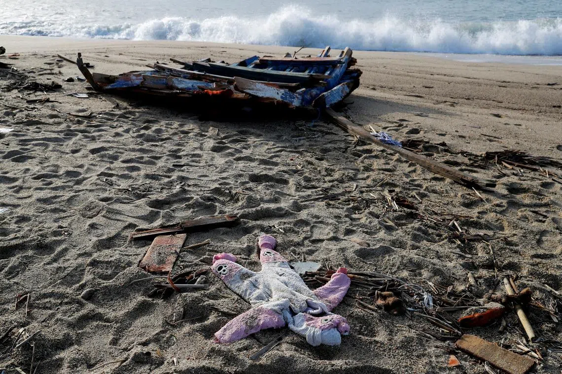 FILE PHOTO: A piece of a boat and a piece of clothing from a deadly migrant shipwreck are seen in Steccato di Cutro near Crotone, Italy, February 28, 2023. REUTERS/Remo Casilli/File Photo