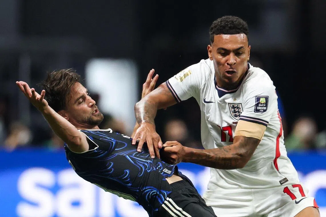 Midfielder Morgan Rogers (right) and defender Nicolas Tagliafico fighting for the ball during the 2026 World Cup semi-final between England and Argentina on July 15.