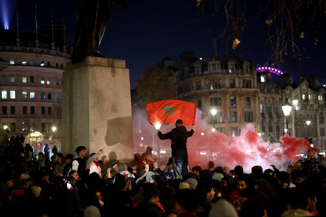 Morocco fans celebrate after reaching the semi finals.