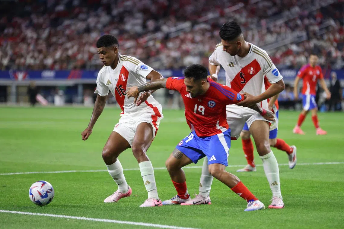 Marcos Bolados of Chile battling for the ball with Wilder Cartagena (left) and Carlos Zambrano of Peru in their Copa America Group A match at AT&T Stadium on June 21, 2024 in Arlington, Texas.