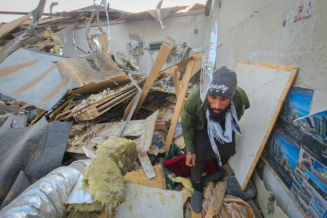 A man walks through debris lying in a ward of a drug users rehabilitation hospital destroyed in what the Taliban said was a Pakistani air strike in Kabul, Afghanistan, March 17, 2026. REUTERS/Yunus Yawar