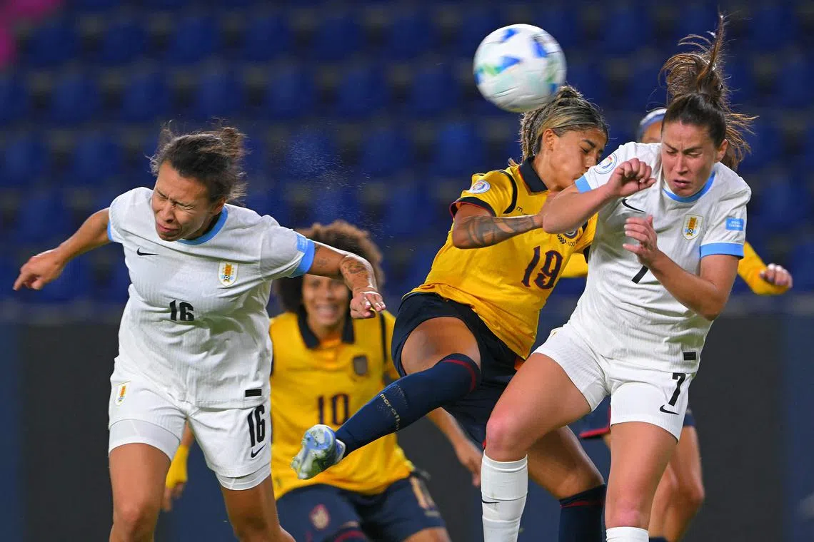 Uruguay defenders Yannel Correa (left) and Stephanie Tregartten jumping for the ball with Ecuador defender Kerlly Real in the Women's Copa America 2025 football match at the IDV Stadium in Quito on July 11, 2025.