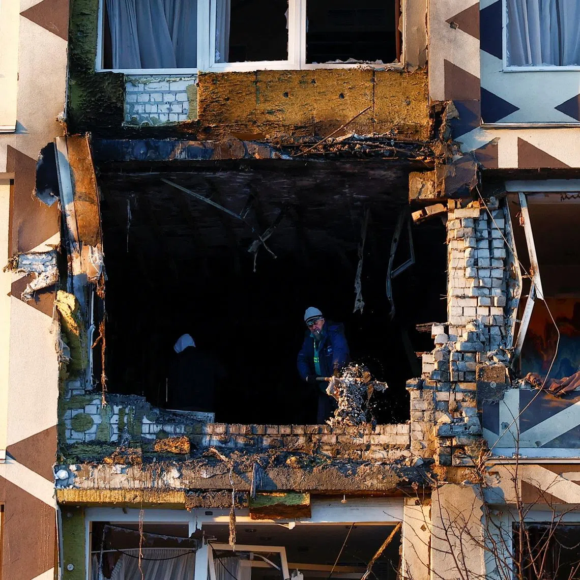 Employees remove debris at the site of a private hospital hit by Russian drone strikes, amid Russia's attack on Ukraine, in Kyiv, Ukraine January 5, 2026. REUTERS/Valentyn Ogirenko