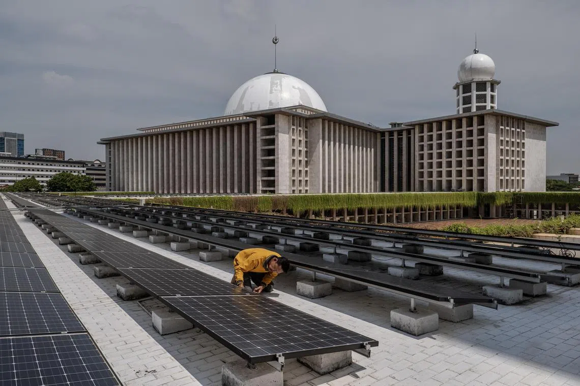 A worker inspects solar panels that provide electrical power to Istiqlal Mosque in Jakarta, Indonesia on Dec. 15, 2023. High-ranking scholars and clergy have issued fatwas, or edicts, on how to rein in climate change. On a smaller scale, Muslim activists are telling their friends, family and neighbors that their duty to save the environment is embedded in the Quran. (Ulet Ifansasti/The New York Times)