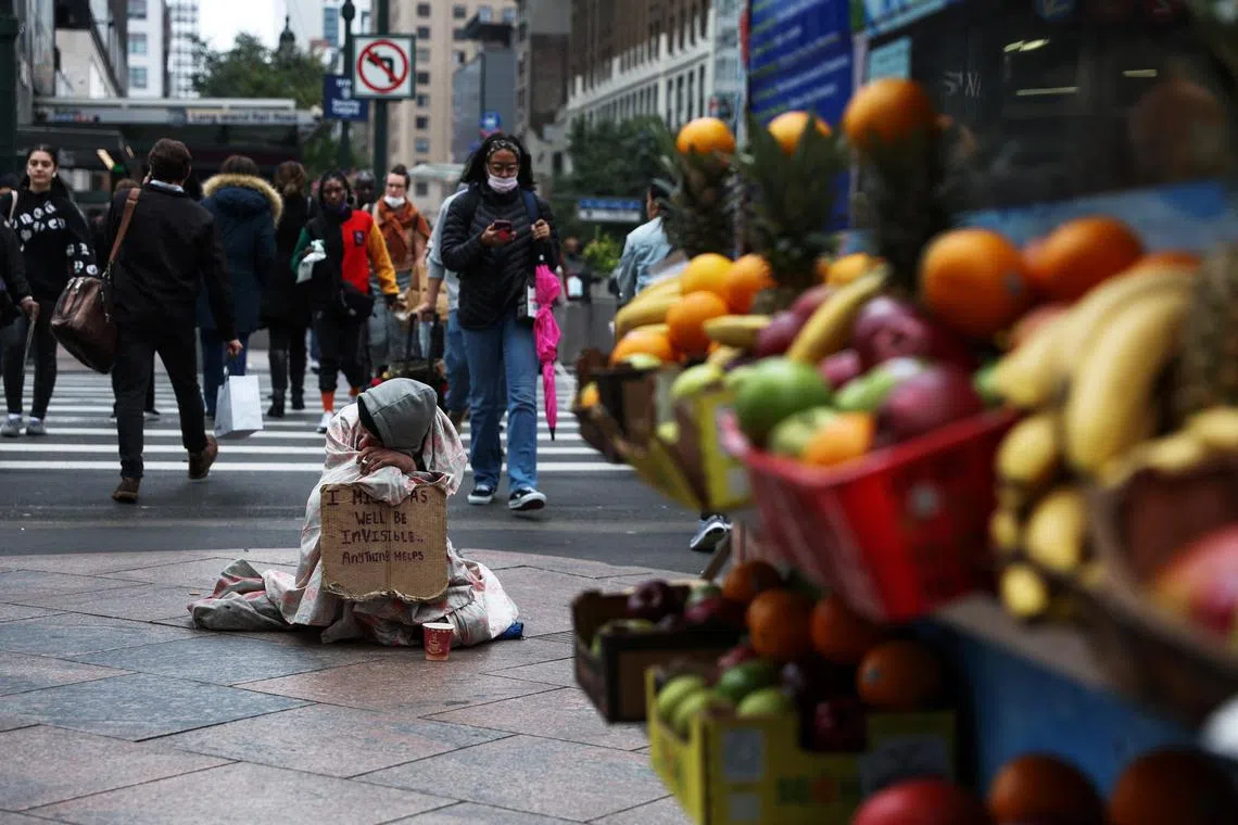 Alan, 39, who said he has been homeless living in the streets for two years, sits on a corner for spare change outside Pennsylvania Station in New York City, U.S., October 24, 2022.  REUTERS/Shannon Stapleton
