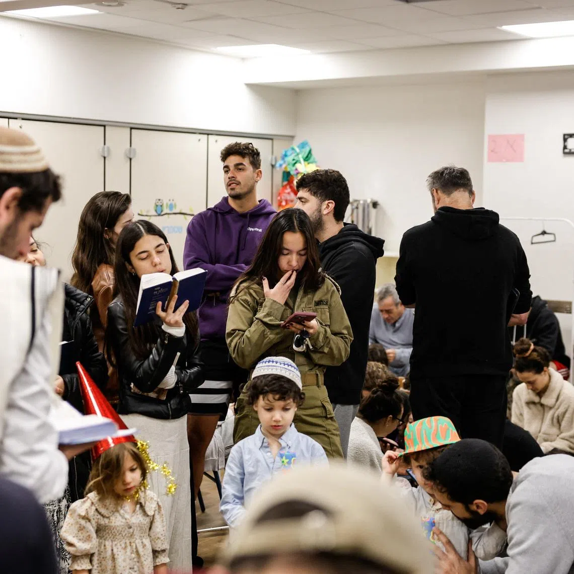 Israelis gather in a bomb shelter, after missiles were launched towards Israel from Iran following strikes by Israel and the U.S. on Iran, in Tel Aviv, Israel February 28, 2026. REUTERS/Tomer Appelbaum