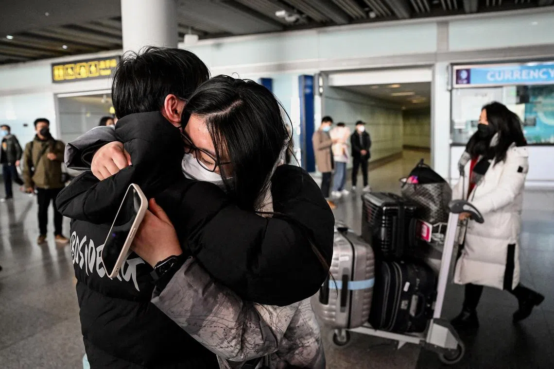 A passenger receiving a hug at the arrival hall for international flights at the Capital International Airport in Beijing on Jan 8, 2023. 