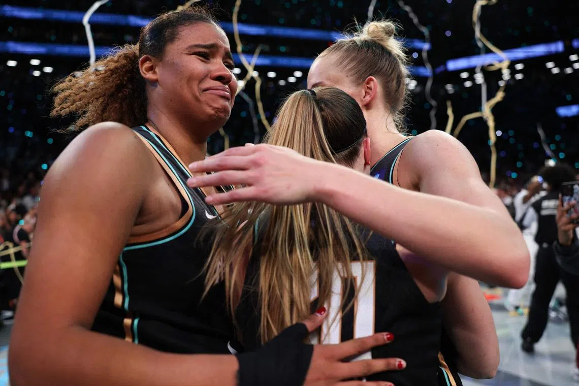 (From left) Nyara Sabally, Leonie Fiebich and Sabrina Ionescu of New York Liberty celebrate after winning Game Five of the WNBA Finals at Barclays Centre on Oct 21.